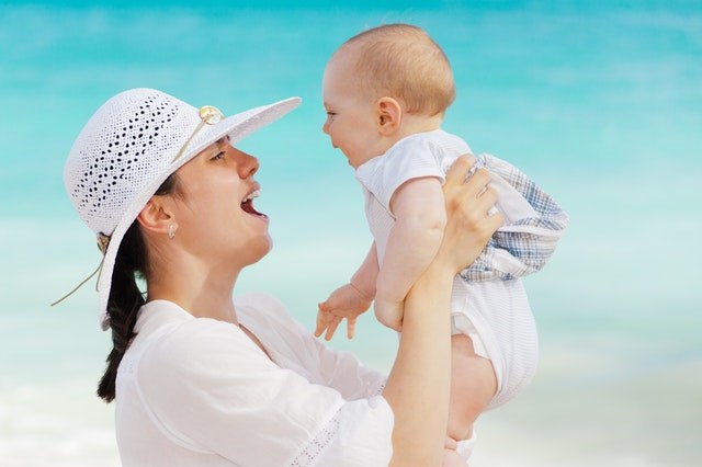 Mother and baby laughing in the sun