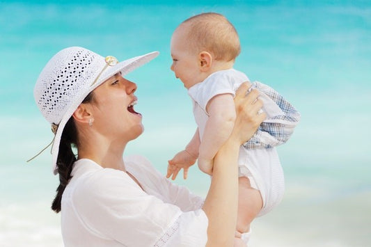 Mother and baby laughing in the sun