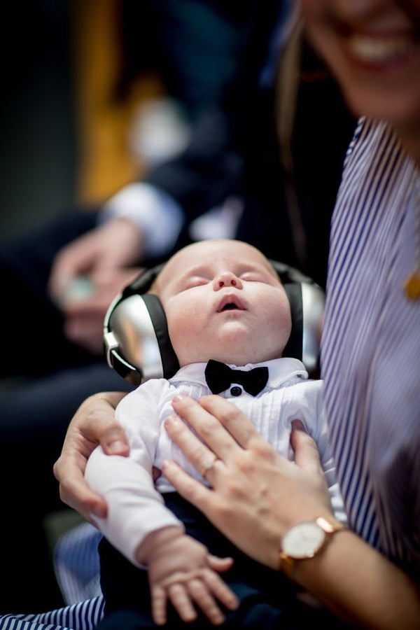 Baby wearing ear defenders